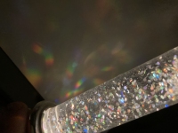 Liquid filled electric candle with holographic glitter.